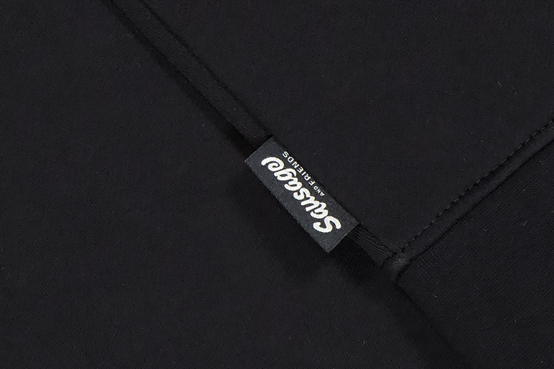 black hoodie showing sausage and friends label on the hoodie